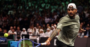 Nick Kyrgios returns the ball to Aryna Sabalenka during their Battle of the Sexes tennis match, Dubai, UAE, Dec. 28, 2025. (AP Photo)
