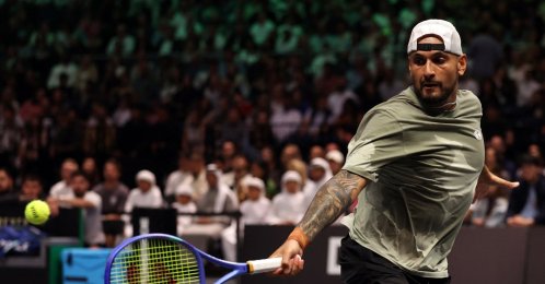 Nick Kyrgios returns the ball to Aryna Sabalenka during their Battle of the Sexes tennis match, Dubai, UAE, Dec. 28, 2025. (AP Photo)