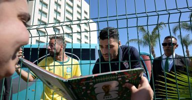 Iran's forward Mehdi Taremi signs autographs for a fan outside the Marriott Hotel before leaving for a training session ahead of the 2026 FIFA World Cup football tournament, Tijuana, Mexico, June 10, 2026. (AFP Photo)