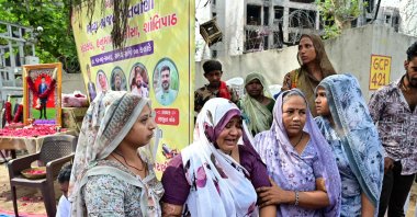 The mother (C) of Air India Flight 171 plane crash victim Akash Patni grieves at the crash site on the first anniversary of the disaster, Ahmedabad, India, June 12, 2026. (AFP Photo)