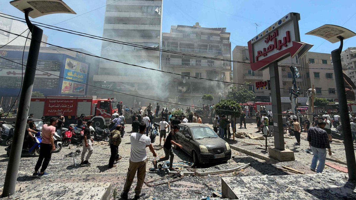 People gather at the site of an Israeli airstrike that targeted a building in the southern suburbs of Beirut, Lebanon, June 14, 2026. (AFP Photo)