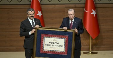 President Recep Tayyip Erdoğan is presented with a framed version of the famed verse “prepare for war if you want peace” by NSC Secretary-General Okay Memiş, Ankara, Türkiye, June 9, 2026. (AA Photo)
