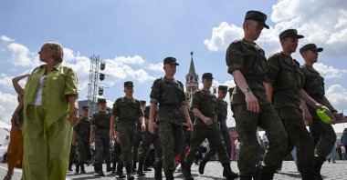 Russian officers walk along Red Square during the Red Square Book Festival with the Kremlin's Spasskaya tower in the background, central Moscow, Russia, June 5, 2026. (AFP Photo)