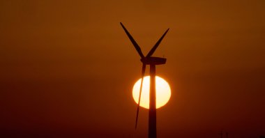 The sun sets behind a wind turbine at the Capelada wind farm, Cedeira, northwestern Spain, May 26, 2026. (AFP Photo)