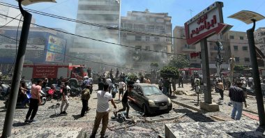 People gather at the site of an Israeli airstrike that targeted a building in the southern suburbs of Beirut, Lebanon, June 14, 2026. (AFP Photo)