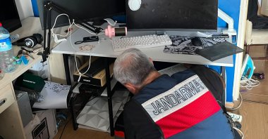 A gendarmerie officer examines digital evidence during a cybercrime operation, Istanbul, Türkiye, June 13, 2026. (AA Photo)