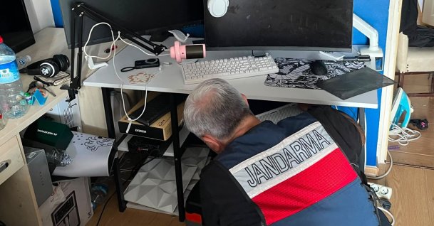 A gendarmerie officer examines digital evidence during a cybercrime operation, Istanbul, Türkiye, June 13, 2026. (AA Photo)