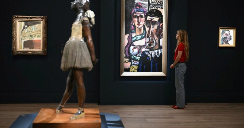 A staff member (R) poses next to Max Beckmann’s “Artisten” (back C), during a media preview by Sotheby's, London, U.K., June 11, 2026. (AFP Photo)