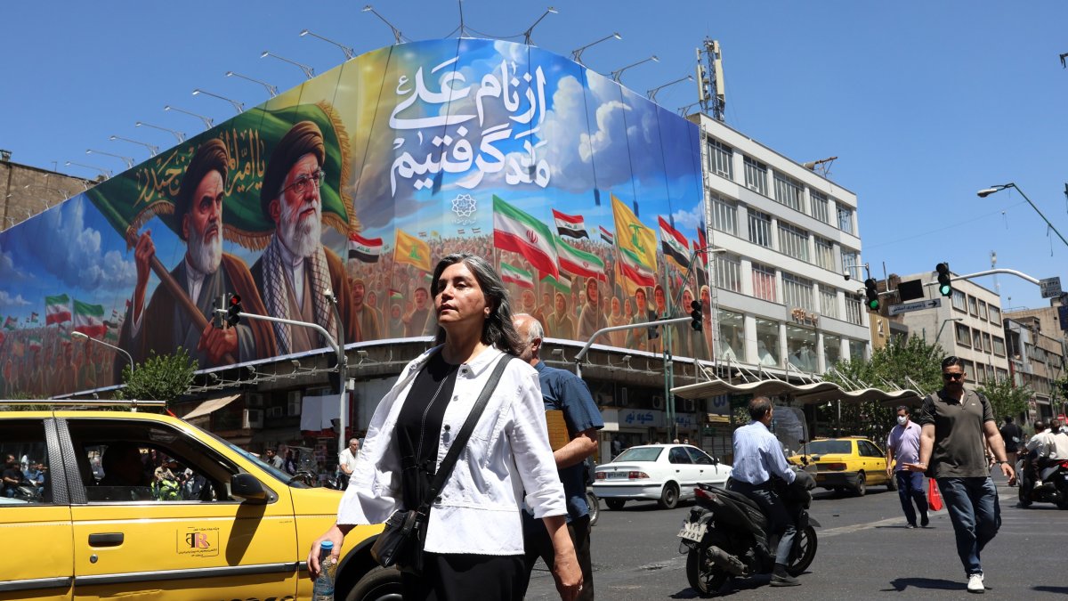 People walk past a billboard of the late Iranian supreme leaders Ayatollah Ruhollah Khomeini and Ayatollah Ali Khamenei on a street in Tehran, Iran, June 15, 2026. (EPA Photo)