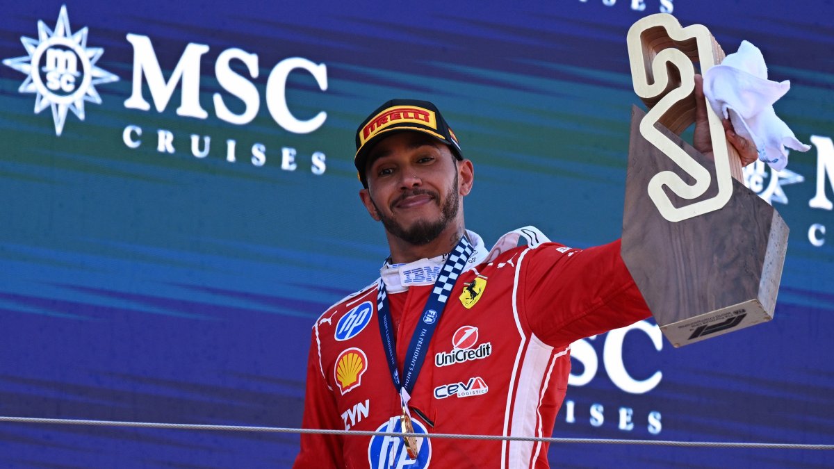 First-placed Scuderia Ferrari driver Lewis Hamilton of Britain celebrates with the trophy on the podium after the Formula One Grand Prix of Barcelona-Catalunya at Circuit de Barcelona-Catalunya track, Barcelona, Spain, June 14, 2026. (AA Photo)
