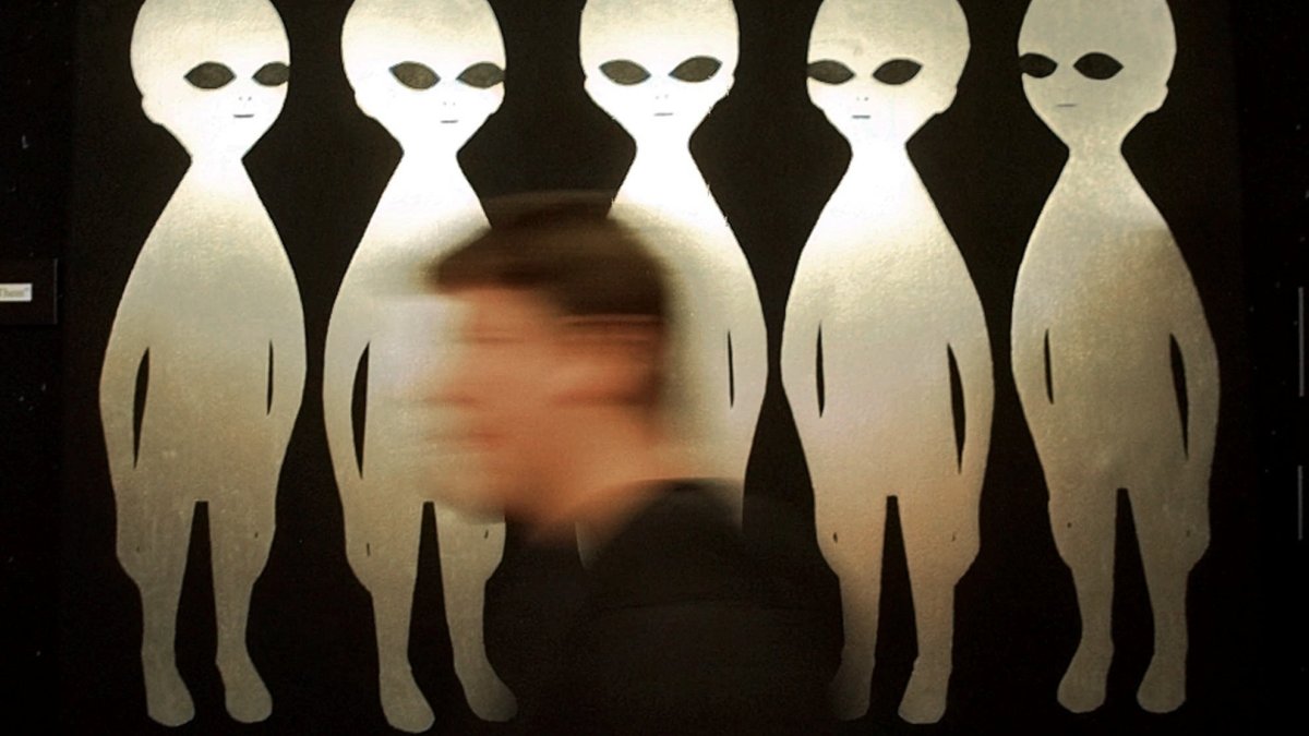 A person passes a painting inside the International UFO Museum and Research Center in Roswell, New Mexico, U.S., June 10, 1997. (AP Photo)