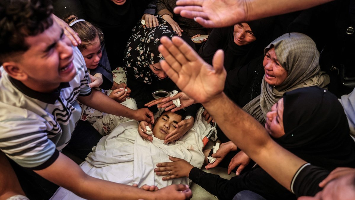 A Palestinian youth reacts as he and others mourn over the body of a boy killed in an overnight Israeli military strike, in Khan Younis, southern Gaza Strip, June 14, 2026. (AFP Photo)