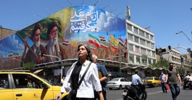 People walk past a billboard of the late Iranian supreme leaders Ayatollah Ruhollah Khomeini and Ayatollah Ali Khamenei on a street in Tehran, Iran, June 15, 2026. (EPA Photo)