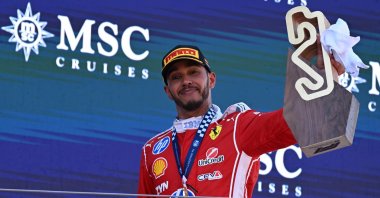 First-placed Scuderia Ferrari driver Lewis Hamilton of Britain celebrates with the trophy on the podium after the Formula One Grand Prix of Barcelona-Catalunya at Circuit de Barcelona-Catalunya track, Barcelona, Spain, June 14, 2026. (AA Photo)
