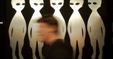A person passes a painting inside the International UFO Museum and Research Center in Roswell, New Mexico, U.S., June 10, 1997. (AP Photo)