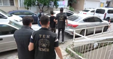 Suspects are escorted by police after being referred to court following a FETÖ-related operation in Izmir, western Türkiye, June 12, 2026. (IHA Photo)