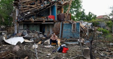 Resident Vasyl sits and smokes in front of his house, which was damaged during Russian missile and drone strikes, amid Russia's attack on Ukraine, in Kyiv, Ukraine, June 15, 2026. (Reuters Photo)