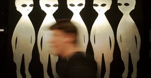 A person passes a painting inside the International UFO Museum and Research Center in Roswell, New Mexico, U.S., June 10, 1997. (AP Photo)