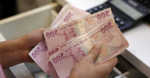 A money changer counts Turkish lira bills at an currency exchange office in central Istanbul, Türkiye, Aug. 21, 2015. (Reuters Photo)