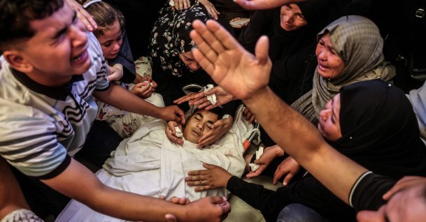 A Palestinian youth reacts as he and others mourn over the body of a boy killed in an overnight Israeli military strike, in Khan Younis, southern Gaza Strip, June 14, 2026. (AFP Photo)