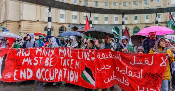 People carry a banner through the rain during a demonstration organized by the Belgian National Coalition for Palestine calling for the Palestinian people's right to self-determination and return, in Brussels, Belgium, May 17, 2026. (EPA File Photo)