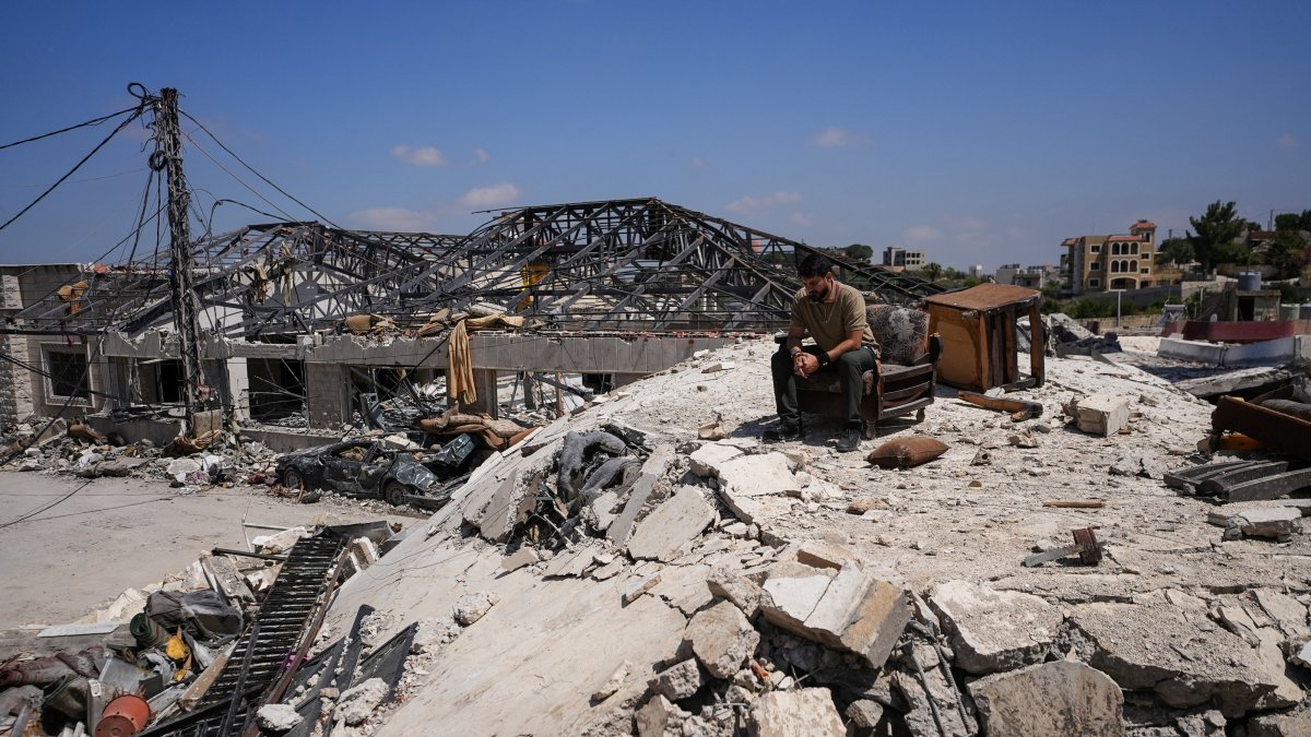 A man sits amid the rubble in Jibchit in the Nabatieh district, Lebanon, June 16, 2026. (Reuters Photo)