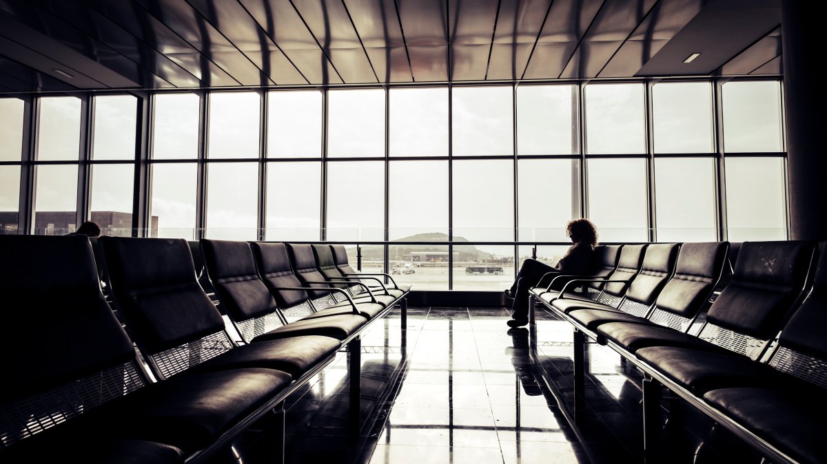 A person sits alone at the airport. (Shutterstock Photo)
