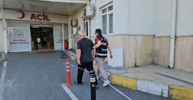 A police officer escorts a suspect to a routine medical check before he is transferred to prison, Istanbul, Türkiye, June 16, 2026. (İHA Photo)