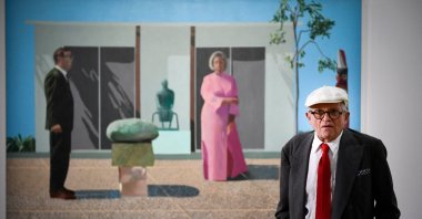 British artist David Hockney poses in front of his painting "Fred and Marcia Weisman" during a photo session at the Pompidou Centre, Paris, France, June 16, 2017. (AFP Photo)