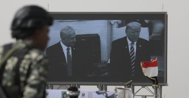 A Houthi soldier stands guard in front of a digital billboard featuring U.S. President Donald Trump and Israeli Prime Minister Benjamin Netanyahu, in Sana'a, Yemen, May 18, 2026. (EPA Photo)