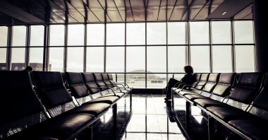 A person sits alone at the airport. (Shutterstock Photo)