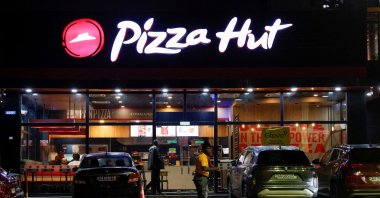 A security guard stands in front of a Pizza Hut fast food restaurant in Abidjan, Ivory Coast, Oct. 5, 2024. (Reuters Photo)