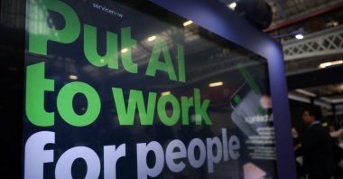 A message reading "Put AI to work for people" is displayed on a screen during the London Tech Week at Olympia, London, U.K., June 8, 2026. (Reuters Photo)