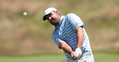 Scottie Scheffler chips onto hole 13 during a practice round for the U.S. Open golf tournament, New York, U.S., June 15, 2026. (Reuters Photo)