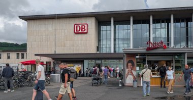 People walk and wait outside Wuerzburg Railway Station during changing weather conditions in Wuerzburg, Bavaria, Lower Franconia, Germany, July 26, 2025. (AFP File Photo)