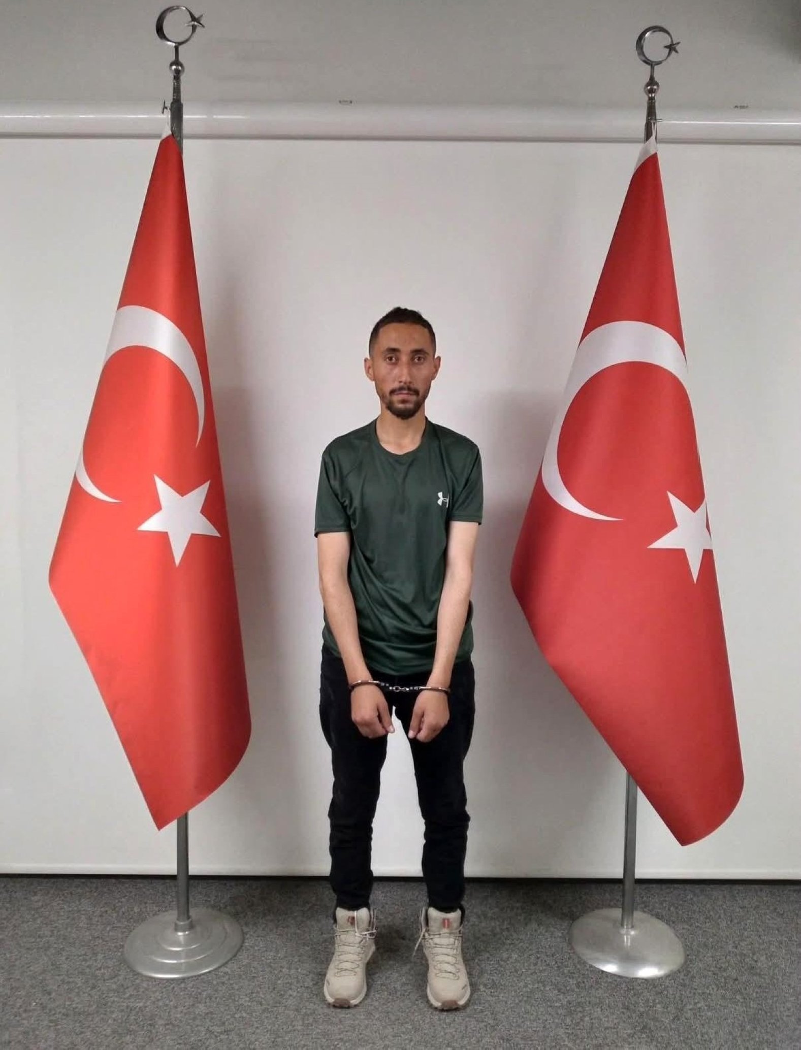 An undate photo distributed to the media shows Ahmet Kazancı in handcuffs in an undisclosed location.