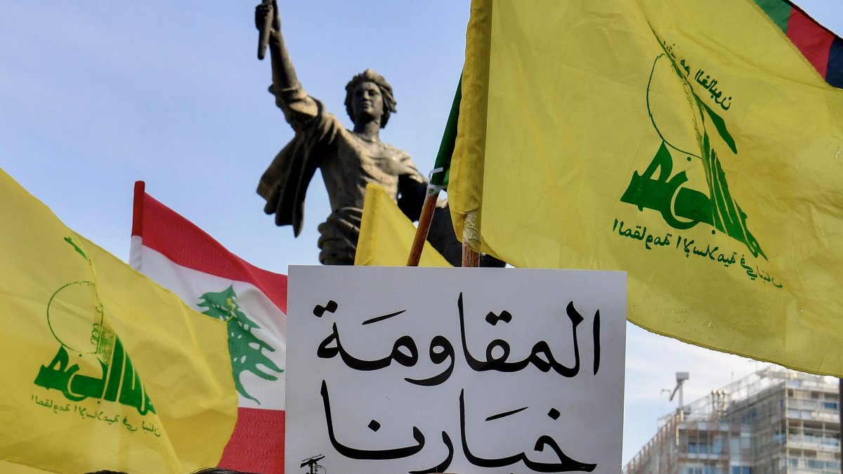 Supporters of Hezbollah carry flags and a placard bearing the Arabic phrase "Resistance is our choice” during a protest, Beirut, Lebanon, 31 May 2026 (EPA Photo)