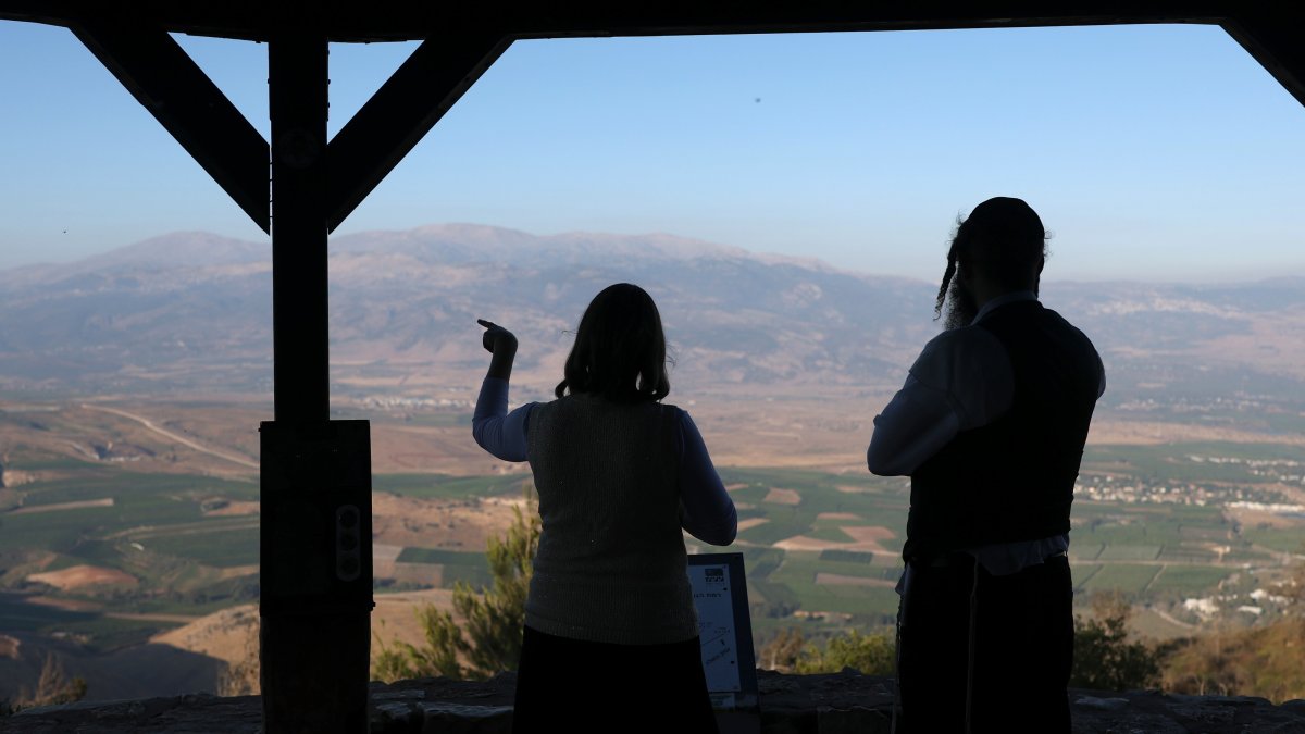 Members of an ultra-Orthodox Jewish family stand at a viewpoint overlooking the Lebanese side of the border, Misgav Am, Israel, June 16, 2026. (EPA Photo)