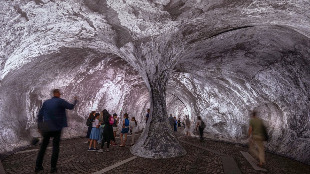 Visitors walk into the artwork "The Pont Neuf Cave" by French street artist JR on the Pont Neuf bridge, Paris, France, June 16, 2026. (AP Photo)