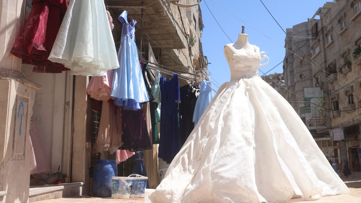 A wedding dress is displayed outside a dressmaker's workshop in the city of Khan Yunis, Palestine, June 13, 2026. (AFP Photo)