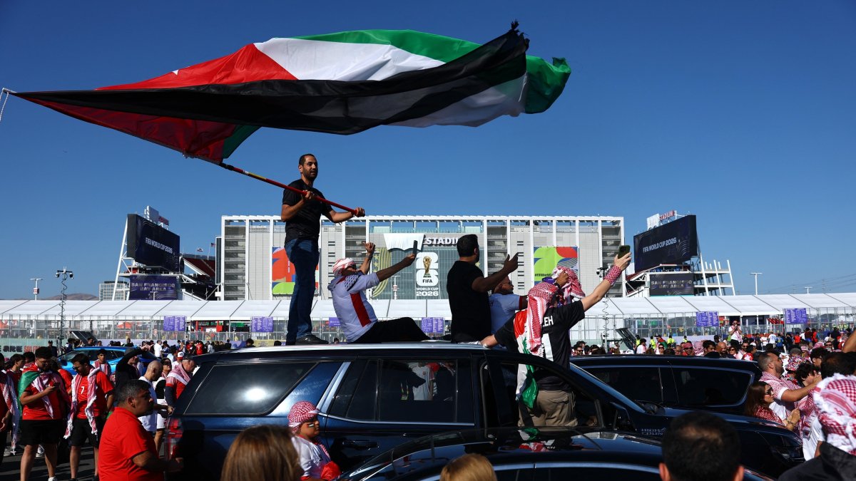 A Jordan fan stands on top of a car waving their national flag outside the stadium before the 2026 FIFA World Cup Group J match against Austria at San Francisco Bay Area Stadium, Santa Clara, California, U.S., June 16, 2026. (Reuters Photo)