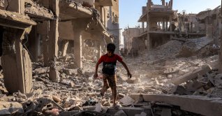  A boy walks through the rubble of a building that was destroyed following Israeli bombardment after an evacuation order, at the Maghazi camp for Palestinian refugees in the central Gaza Strip, June 12, 2026. (AFP Photo)