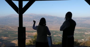 Members of an ultra-Orthodox Jewish family stand at a viewpoint overlooking the Lebanese side of the border, Misgav Am, Israel, June 16, 2026. (EPA Photo)