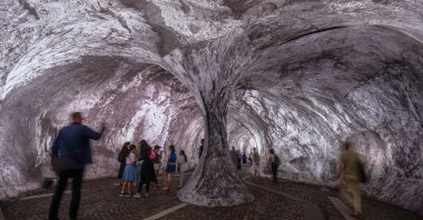 Visitors walk into the artwork "The Pont Neuf Cave" by French street artist JR on the Pont Neuf bridge, Paris, France, June 16, 2026. (AP Photo)
