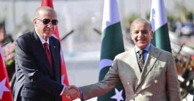 President Recep Tayyip Erdoğan shakes hands with Pakistan's Prime Minister Shehbaz Sharif during a welcome ceremony, Islamabad, Pakistan, Feb. 13, 2025. (AP Photo)