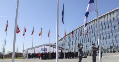 Finnish military personnel install the Finnish national flag at the NATO headquarters in Brussels, April 4, 2023. (AFP Photo)