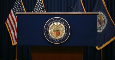 The US Federal Reserve seal is seen on a lectern before US Federal Reserve chairman Kevin Warsh holds a press conference in Washington, DC, June 17, 2026. (AFP Photo)