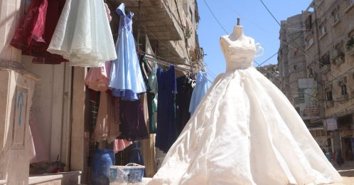 A wedding dress is displayed outside a dressmaker's workshop in the city of Khan Yunis, Palestine, June 13, 2026. (AFP Photo)