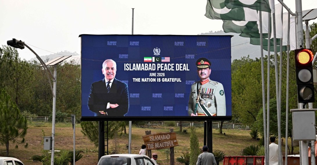 Commuters ride past an electronic board featuring Pakistan's Prime Minister Shehbaz Sharif with Army Chief and Field Marshal Syed Asim Munir, displayed along a roadside in Islamabad, June 17, 2026. (AFP Photo)