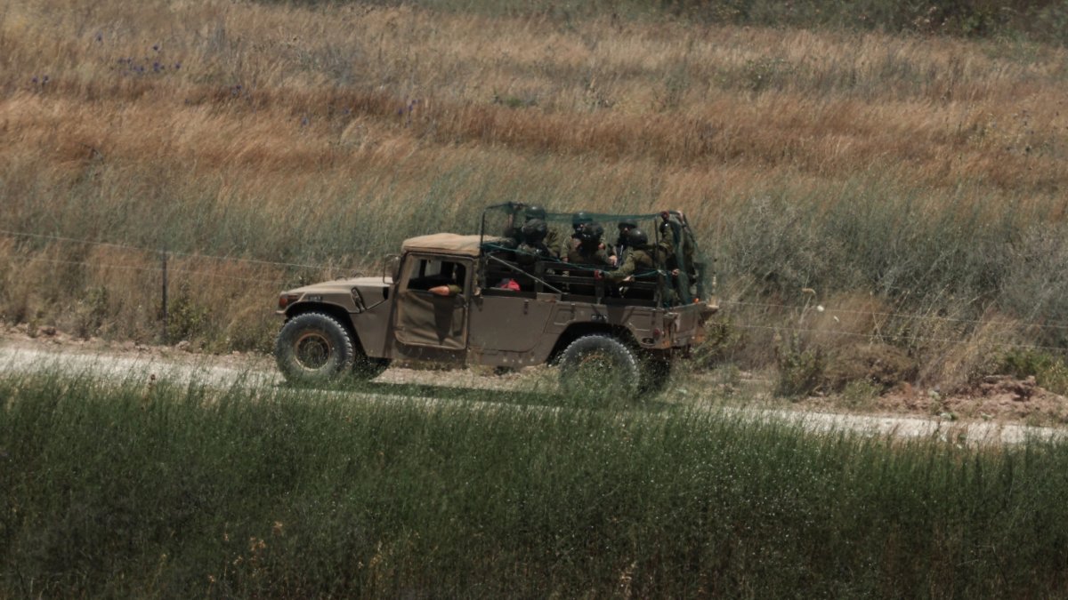An Israeli military vehicle covered in an anti-drone mesh screen maneuvers on the Lebanese side of the border, June 18, 2026. (EPA Photo)